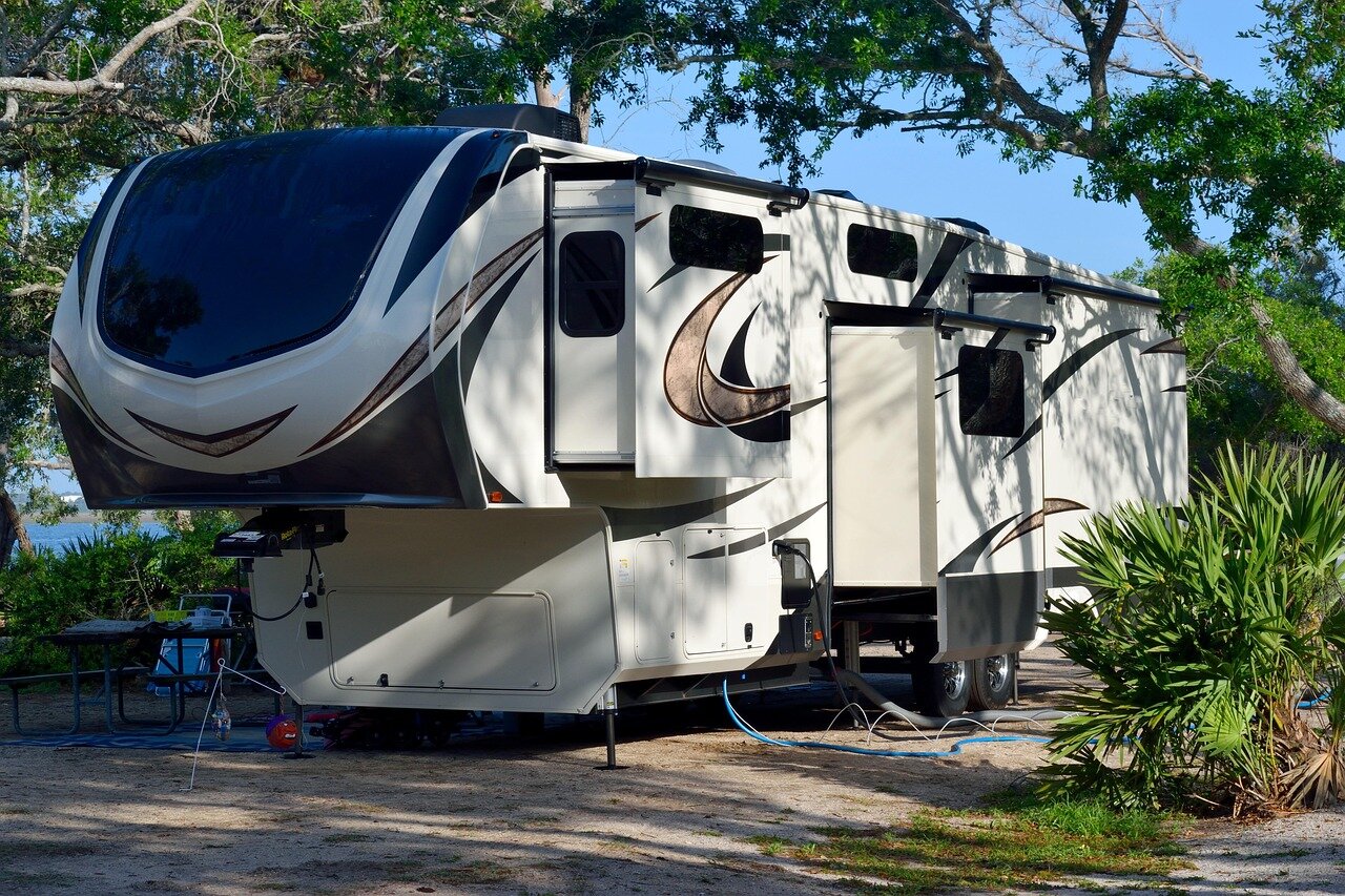 Modern fifth wheel RV set up at a campsite