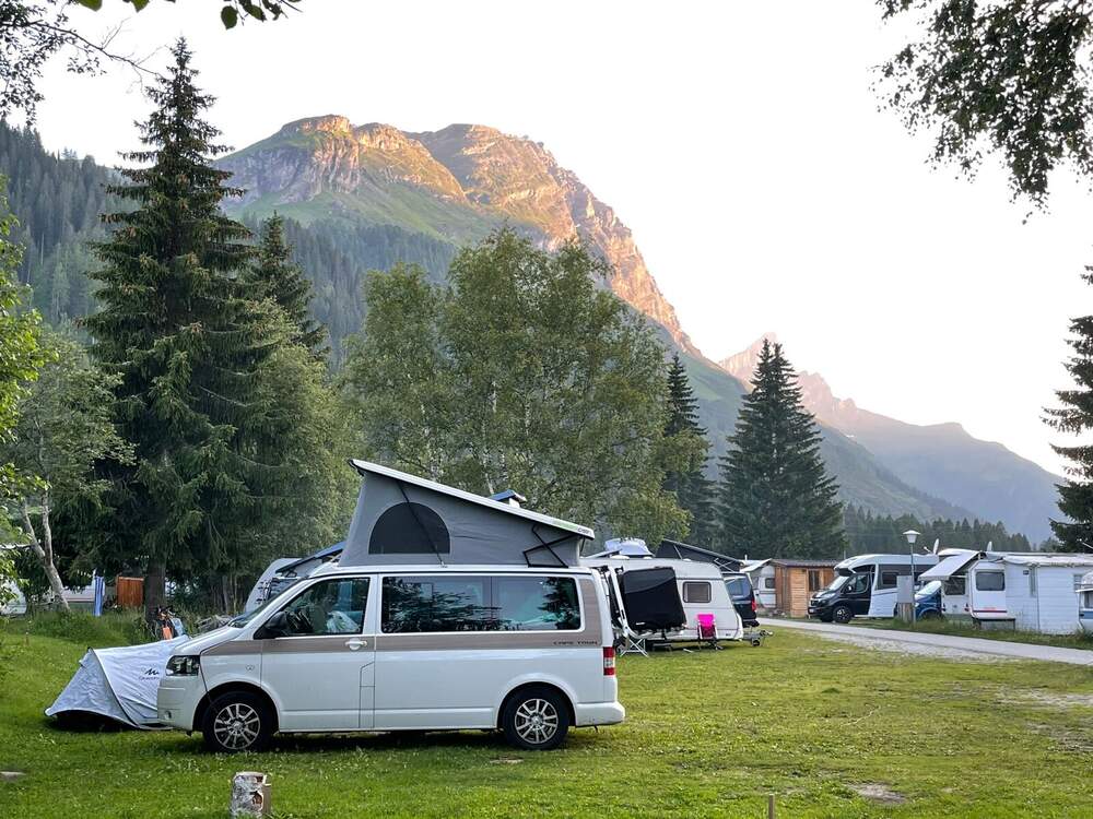 Modern camper van at a mountain campground